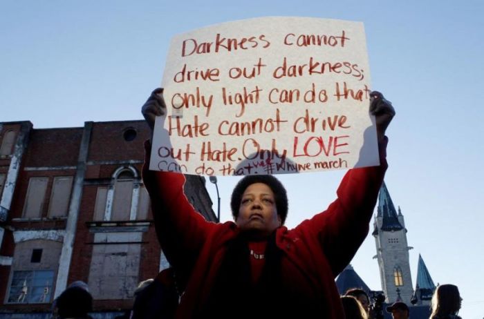 Barbara Carter of Tuscaloosa holds a sign as she waits on a commemorative march by the cast of the movie 'Selma' in Selma, Alabama January 18, 2015.