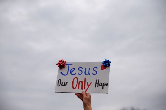 Credit : A woman holds a sing during the inauguration of U.S. President Donald Trump, in the National Mall in Washington, U.S., January 20, 2017.