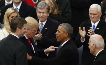 Eric Trump (L) watches as president-elect Donald Trump speaks to U.S. President Barack Obama at Donald Trump's presidential inauguration in Washington, U.S., January 20, 2017.