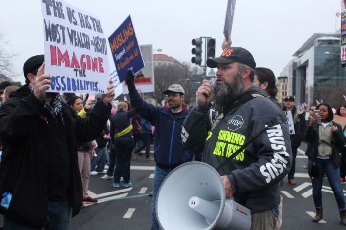 Kentucky-based evangelist Kerrigan Skelly speaks through a megaphone as demonstrators in the Women's March on Washington, D.C. stand in front of him in protest on Jan. 21, 2017.