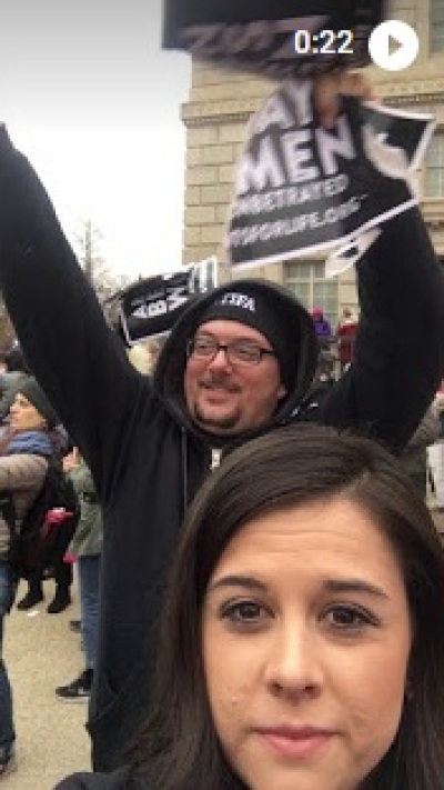 Reagan Barklage, the Students for Life western regional director, films as participants in the Women's March on Washington tear up pro-life signs that belong to the group on Jan. 21, 2017.