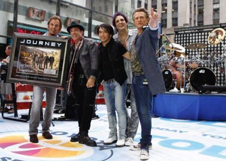 Journey band members (L-R) Jonathan Cain, Neal Schon, Arnel Pineda, Deen Castronovo and Ross Valory pose together after performing on NBC's Today Show in New York July 29, 2011.