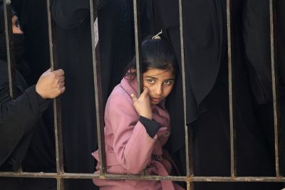 An Internally displaced refugee girl from al-Bab town waits to receive food aid in Ekhtreen town, northern Aleppo countryside, Syria, January 21, 2017.