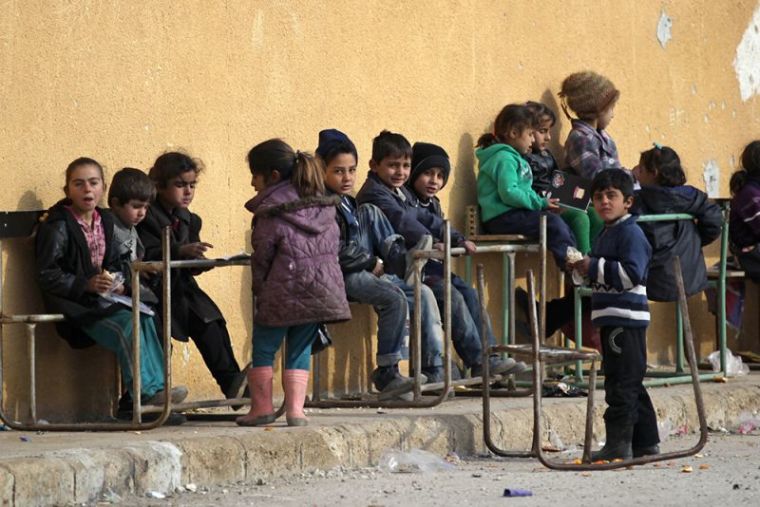 Students sit on damaged desks at the 'Aisha Mother of the BelieversÕ school which was recently reopened after rebels took control of al-Rai town from Islamic State militants, Syria, January 17, 2017.