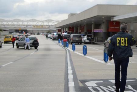 Law enforcement walk outside a terminal after a shooter opened fire at a baggage carousel at Fort Lauderdale-Hollywood International Airport in Florida, January 6, 2017.