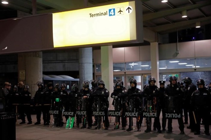 Port Authority Police Officers stand guard outside Terminal 4 during a protest against Donald Trump's travel ban at John F. Kennedy International Airport in Queens, New York, U.S., January 28, 2017.