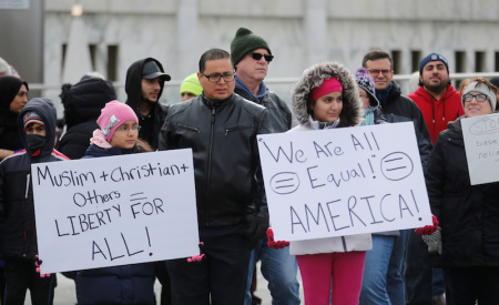 Rafik Assi (C ) and his daughters Mirna (L) and Malak attend a rally against a temporary travel ban signed by U.S. President Donald Trump in an executive order during a protest in Dearborn, Michigan, U.S., January 29, 2017.