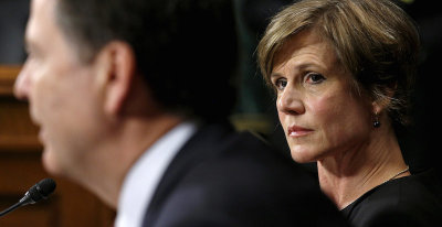 Deputy Attorney General Sally Quillian Yates (R) listens as FBI Director James Comey speaks during a Senate Judiciary Committee hearing in Washington July 8, 2015.