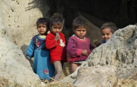 Children of Dalits stand inside a broken house on the outskirts of Lucknow January 16, 2008.