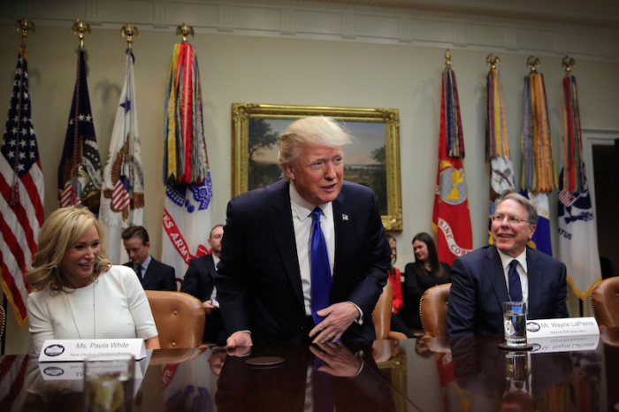 Former U.S. President Donald Trump attends a meeting regarding the supreme court nomination, accompanied by Wayne LaPierre (R), executive vice president of the National Rifle Association and Paula White (L) from the New Christian Destiny Center at the Roosevelt room of the White House in Washington U.S., February 1, 2017.