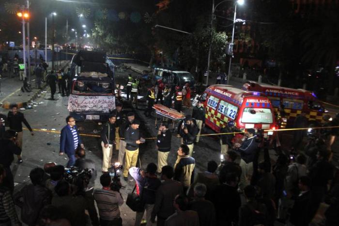 Police and rescue workers work at the scene of a blast in Lahore, Pakistan February 13, 2017.