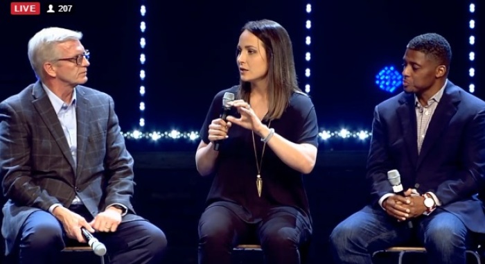 Former Louisiana State University soccer standout Mo Isom (M) speaks at the 'Under Our Skin' forum on race and faith hosted at The Crossing Church in Tampa, Florida on Feb. 16, 2017. Isom is flanked by former NFL running back Warrick Dunn (R) and Detroit pastor J. Kevin Butcher (L)