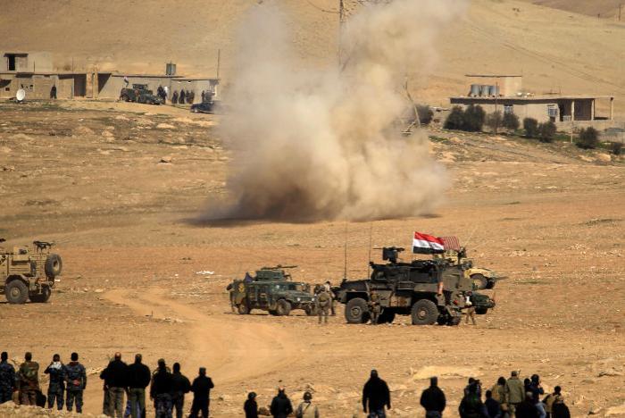 Smoke is seen rising after a rocket landed in the middle of the Iraqi rapid response forces' position during a battle against Islamic State militants in the south of Mosul, Iraq on Feb. 19, 2017.