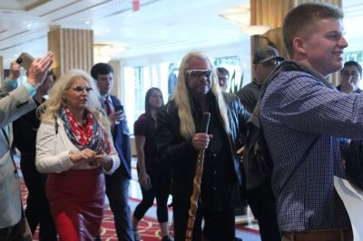 Duane 'Dog the Bounty Hunter' Chapman walks with his wife, Beth, as they are surrounded by fans at the Gaylord National Resort and Convention Center in Oxon Hill, Maryland on Feb.24, 2017.