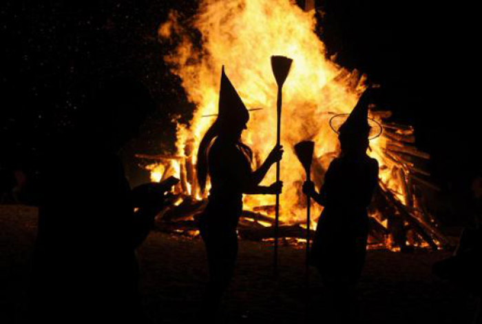 Two women dressed up as witches take pictures in front of the bonfire during the traditional San Juan's (Saint John) night on... June 24, 2015 09:45pm EDT