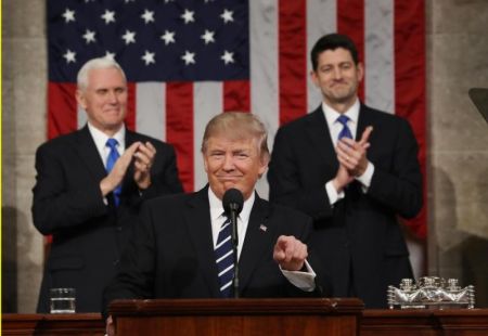 Vice President Mike Pence and Speaker of the House Paul Ryan applaud as President Donald Trump arrives to deliver his first address to a joint session of Congress from the floor of the House of Representatives in Washington.