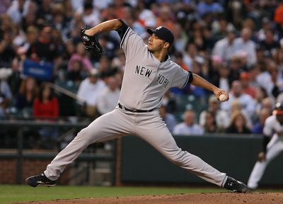 New York Yankees pitcher Andy Pettitte winds up to throw a pitch during a game in 2009.