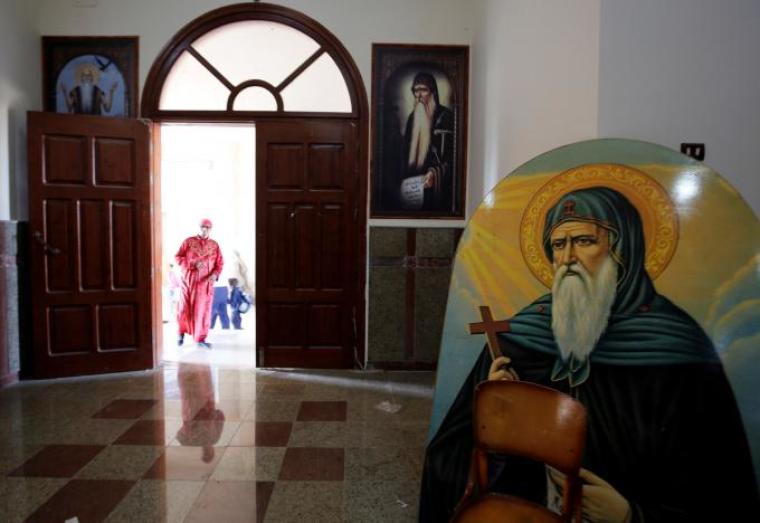 A Christian woman who left with her family from Al-Arish city North Sinai's Governorate capital after the escalation of a campaign targeting Christians by Islamic State militants last week, walks inside the Saint Church in Ismailia, northeast of Cairo, Egypt, February 27, 2017.