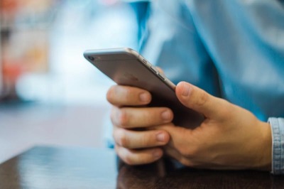 A man views his cell phone.