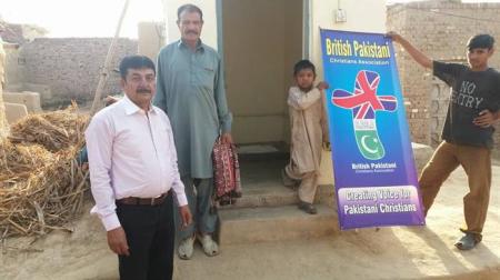 Pakistani Christians in Jaranwala pose in front of a new washroom facility that was built by a government agency in this undated photo.