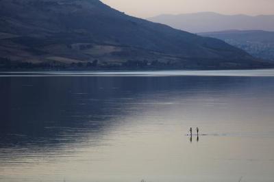 People paddle on a stand-up paddle board in the Sea of Galilee, northern Israel November 8, 2016.