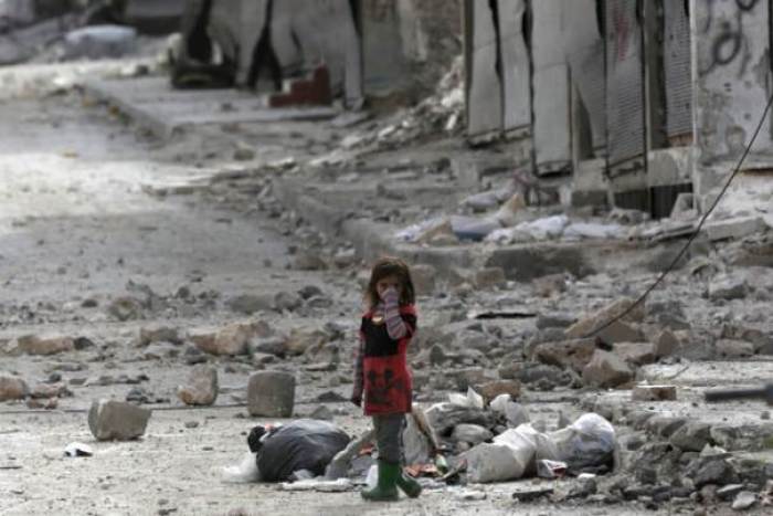 A girl stands amidst the rubble of damaged buildings in the northern Syrian town of al-Bab, Syria, February 28, 2017.