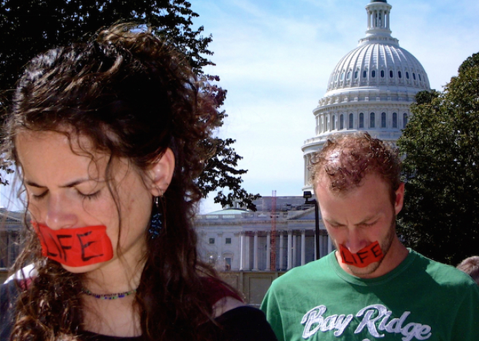 Bound4LIFE team members pray silently at the Supreme Court, with the U.S. Capitol behind them