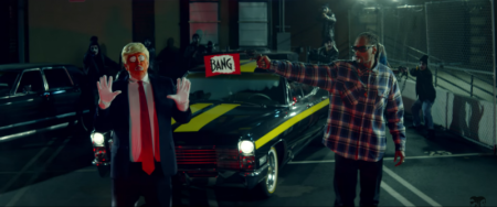 Raper Snoop Dogg aims a toy gun at a clown dressed like Donald Trump in the 'BADBADNOTGOOD - Lavender' video ft. Kaytranada & Snoop, March 12, 2017