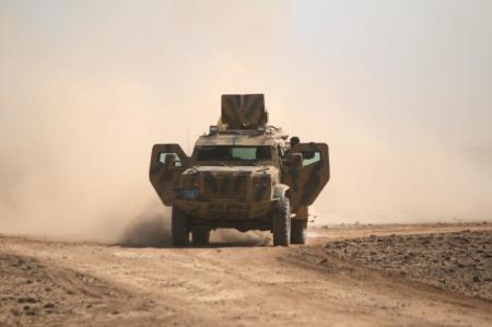 Syrian Democratic Forces(SDF) fighters ride a military vehicle north of Raqqa city, Syria March 8, 2017.