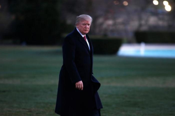 U.S. President Donald Trump walks from Marine One as he returns to the White House in Washington.