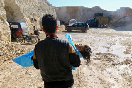 A man carries the body of a dead child, after what rescue workers described as a suspected gas attack in the town of Khan Sheikhoun in rebel-held Idlib, Syria April 4, 2017.