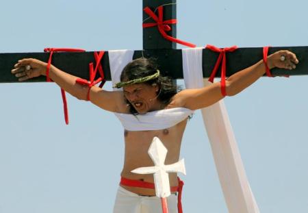 Ruben Enaje, 57, who is portraying Jesus Christ for the 31st time, grimaces in pain as he was nailed on a wooden cross during a Good Friday crucifixion re-enactment in Cutud village, Pampanga province, north of Manila, Philippines April 14, 2017.