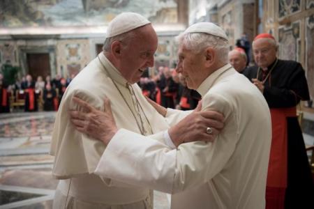 Pope Francis greets his predecessor, Pope Emeritus Benedict XVI, at the Vatican.