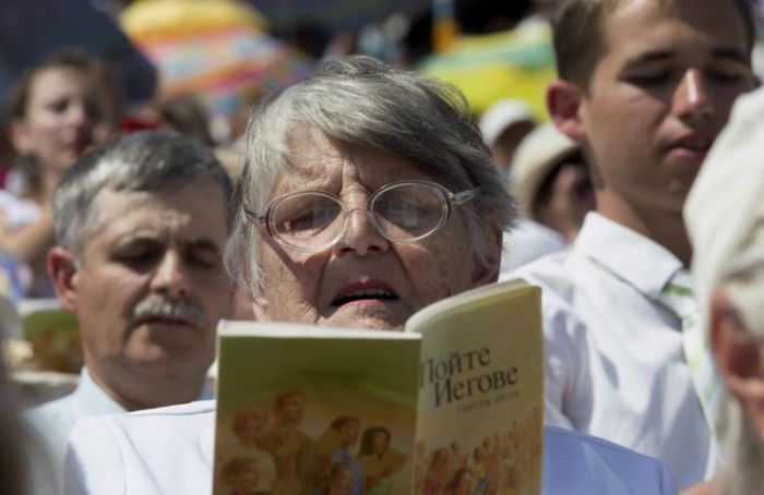 Jehovah's Witnesses pray at a regional congress at Traktar Stadium in Minsk, Belarus, July 25, 2015.