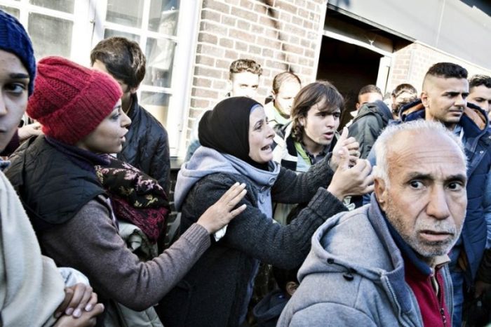 Migrants at Denmark's Padborg Station, after crossing over the border from Germany.