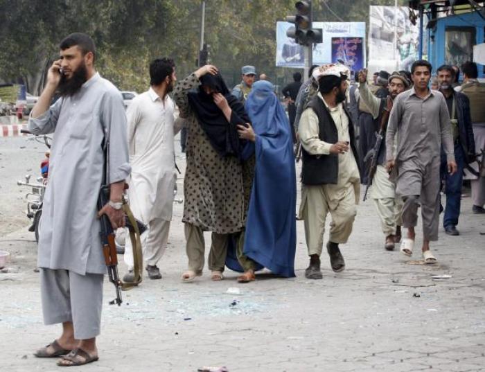 People move to save themselves during the gunfire near the Indian consulate in Jalalabad, Afghanistan March 2, 2016.