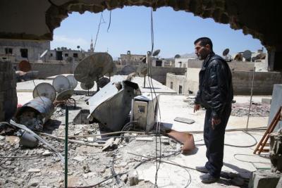 Abu Ghassan, 50, one of the survivors of a chemical attack in the Ghouta region of Damascus that took place in 2013, points at a piece of one of the rockets fired in 2013, as he stands in the Ghouta town of Ain Tarma, Syria April 7, 2017. Picture taken April 7, 2017.