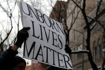 A man stands during an anti-Planned Parenthood vigil outside the Planned Parenthood - Margaret Sanger Health Center in Manhattan, New York, U.S., on Feb. 11, 2017.