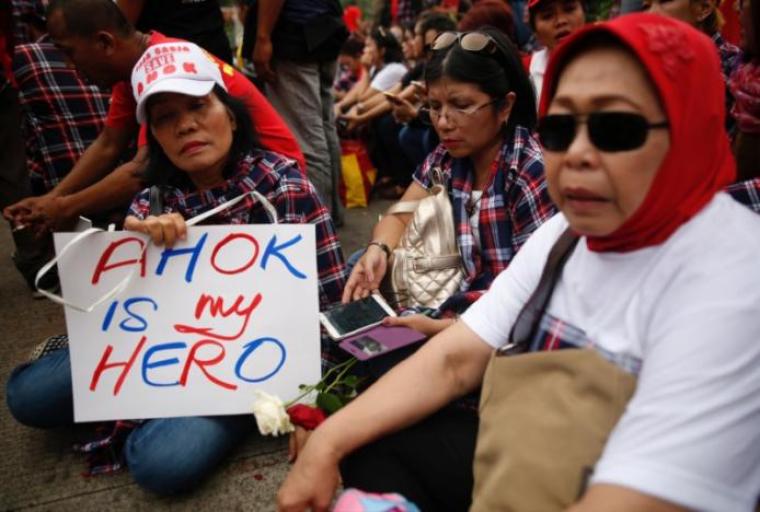 Supporters of Jakarta Governor Basuki Tjahaja Purnama, also known as Ahok, react near the court following his conviction of blasphemy in Jakarta, Indonesia, May 9, 2017.