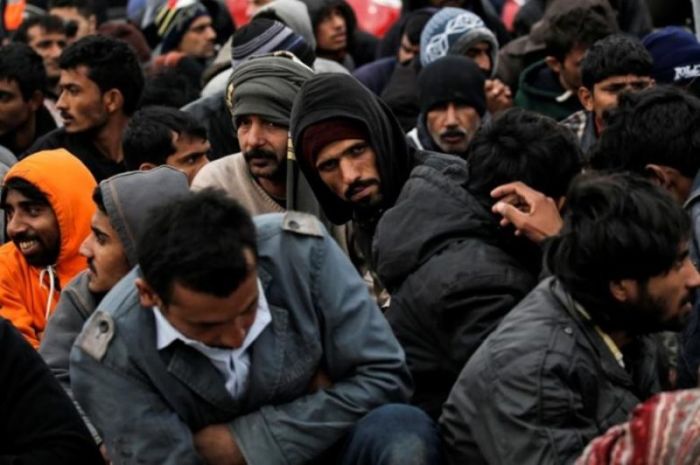 Refugees wait to be transferred to the Moria registration center after arriving at the port of Mytilene on the Greek island of Lesbos, following a rescue operation by the Greek Coast Guard at open sea, on March 22, 2016.