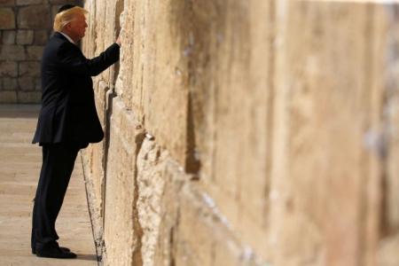 U.S. President Donald Trump places a note in the stones of the Western Wall, Judaism's holiest prayer site, in Jerusalem's Old City on May 22, 2017.