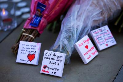 Flowers and messages of condolence are left for the victims of the Manchester Arena attack in central Manchester, Britain May 23, 2017.