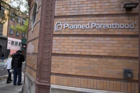 People walk past a Planned Parenthood clinic in the Manhattan borough of New York, November 28, 2015.