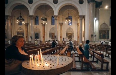 Christian woman lights a candle at Saint Joseph's Roman Catholic Church before Pope Francis is scheduled to visit, in Cairo, Egypt April 23, 2017. Picture taken April 23, 2017.