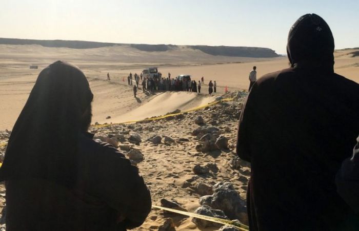 Monks look at the scene of the ISIS attack on a group of Coptic Christians traveling to a monastery in southern Egypt, in Minya, on May 26, 2017.