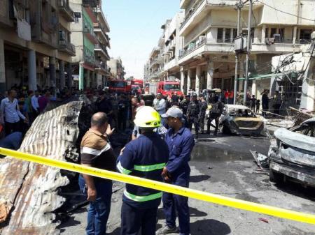 Iraqi security forces and firefighters gather at the site of car bomb attack near a government office in Karkh district in Baghdad, Iraq, May 30, 2017.