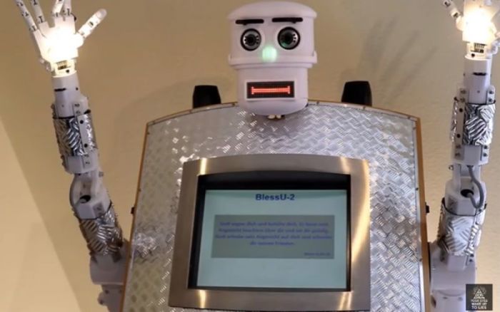 The 'robot priest' says, 'God bless and protect you,' followed by a recitation of a Bible verse while moving its arms and flashing its lights.