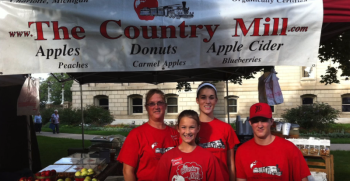 Representatives of Country Mill Farms at a city of East Lansing farmers' market. In May 2017, Country Mill filed a lawsuit against East Lansing over the city banning them because of their refusal to host same-sex weddings on their property.