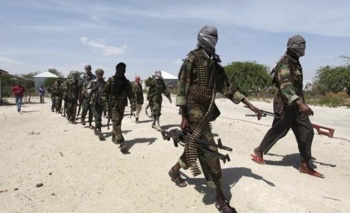 Al Shabaab soldiers patrol in formation along the streets of Dayniile district in Southern Mogadishu, March 5, 2012.