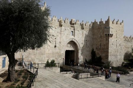 People walk near Damascus Gate leading into Jerusalem's Old City, 2017.